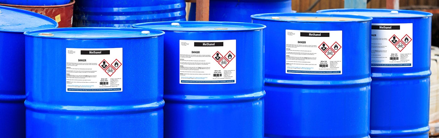 Blue chemical drums with GHS compliant labels